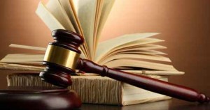 wooden gavel and books on wooden table,on brown background